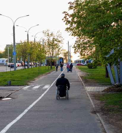 Shot of the handicapped man on the wheelchair on the city streetsの写真素材