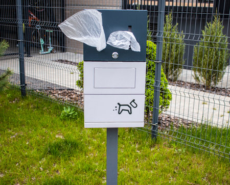 Close up shot of the box with single use plastic bags used for cleaning off pets excrement in the parkの写真素材