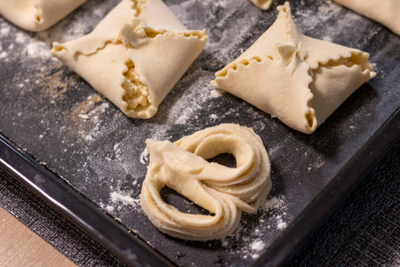 Close up shot of the cottage cheese pastries on the baking tray.