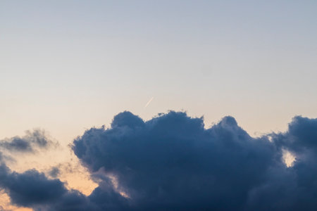 Shot of the contrail between the stormy clouds