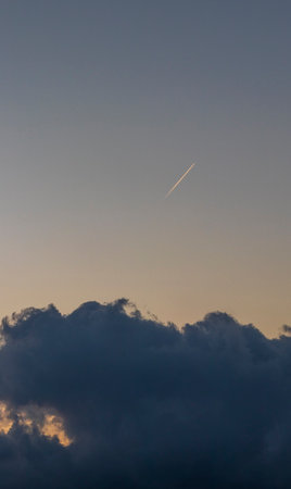 Shot of the contrail between the stormy clouds
