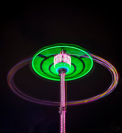 Shot of the light trails from carousel attraction made on long exposureの写真素材