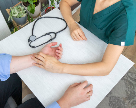 Female doctor measuring the pulse of the patientの写真素材