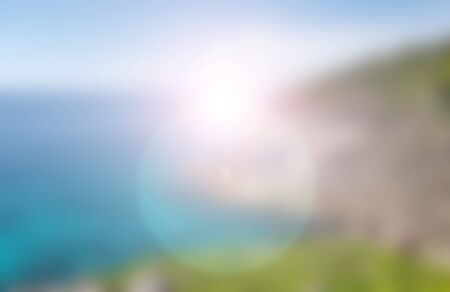 blurred nature background of sea, sky and islands with flareの写真素材