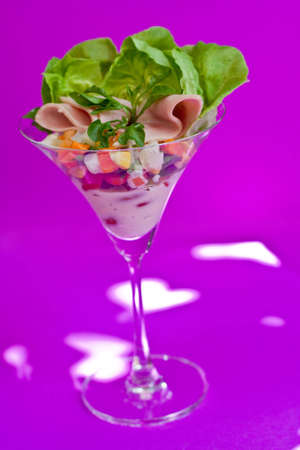Ham cocktail in a martini glass, with cos lettuce and seafood cocktail sauce on violet background with light effect. click for more photo of international food and baverageの写真素材