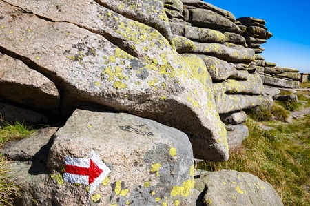 Red tourist sign, arrow, pointing to the right in the Krkonose mountins, Czech republicの写真素材