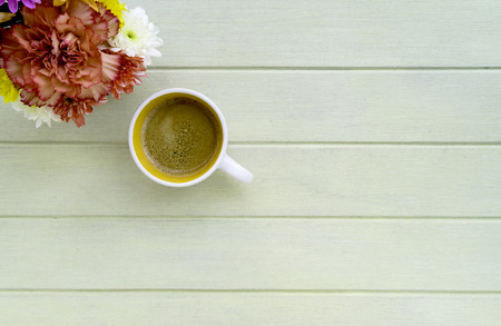 Flower and coffee on wooden table: Flay lay with copy spaceの写真素材