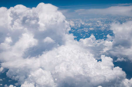 View from airplane window showing blue sky and white cloudsの写真素材