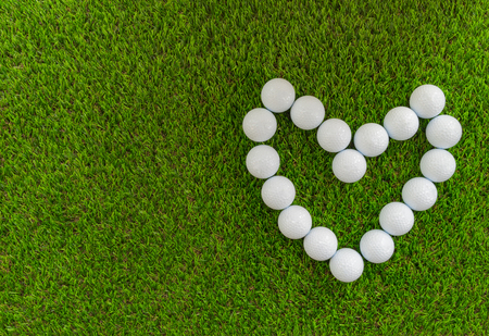 Golf concept : Golf balls arranged as heart symbol.の写真素材