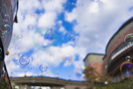 Abstract background : Beautiful bubbles floating on blue sky day. Vintage building in background.