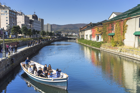 Otaru, Japan - October 19, 2017 : Unknown tourists on Otaru canal cruise, bright beautiful autumn day.のeditorial素材