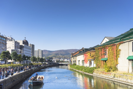 Otaru, Japan - October 19, 2017 : Unknown tourists on Otaru canal cruise, bright beautiful autumn day.のeditorial素材