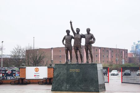 Manchester, UK - March 4, 2018 : The United Trinity Statue in front of The Old Trafford Stadium, the home of Manchester United football club. Raining day.のeditorial素材