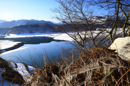 Nishiwaga Town, Iwate Prefecture Snowy scenery of Lake Kinshu in clear weatherの写真素材