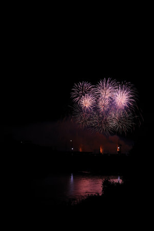 Colorful fireworks of various colors over night sky, celebration and anniversary concept