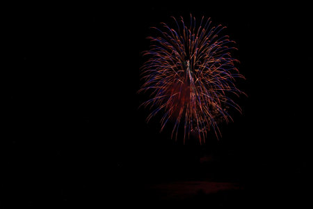 Colorful fireworks of various colors over night sky, celebration and anniversary concept
