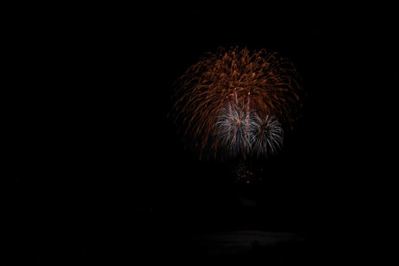 Colorful fireworks of various colors over night sky, celebration and anniversary concept