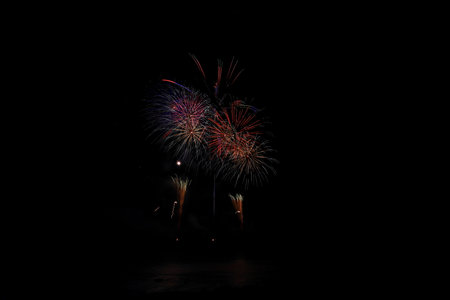 Colorful fireworks of various colors over night sky, celebration and anniversary conceptの写真素材