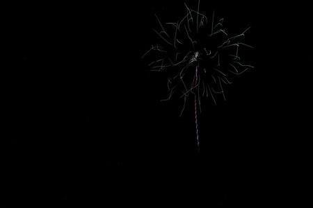 Colorful fireworks of various colors over the water surface of the riverの写真素材