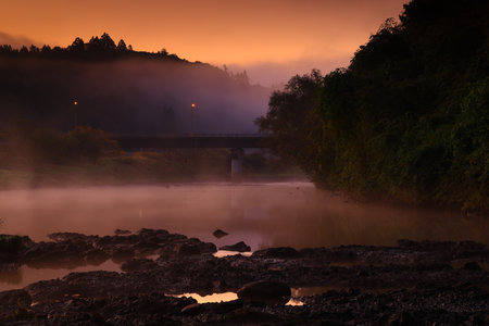 Colorful autumn forest reflected in the lake at sunset. Autumn landscape.の写真素材