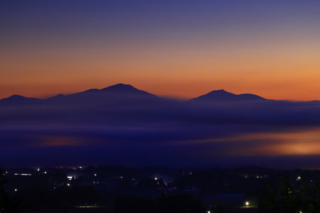 Sunset on the river, with fog and trees in the foreground
