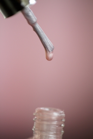 Macro view of a pink colour nail polish with white backgroundの写真素材