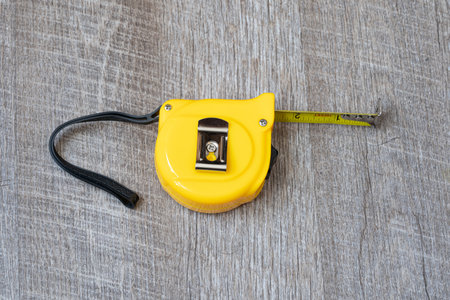 steel metal maesuring tape yelow color macro in a tableの写真素材