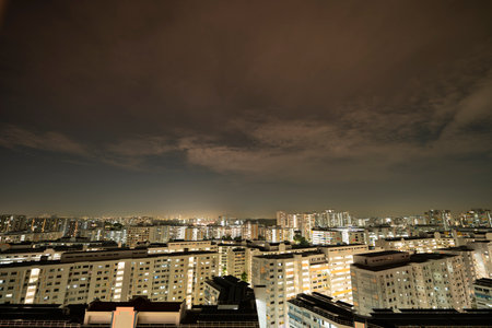 Landscape view of Singapore HDB flats in the evening and night with dramatic clouds
