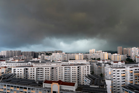 Landscape view of Singapore HDB flats in the evening and night with  with dramatic rain cloudsの写真素材