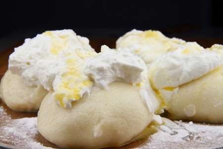 Sweet dumplings filled with fruits. On the top is curd, sugar and butter.の写真素材