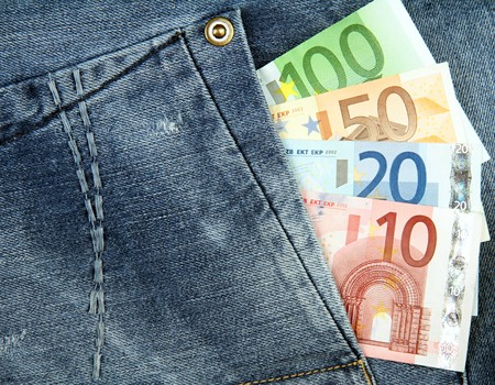 Euro banknotes in pocket of blue jeans.の写真素材