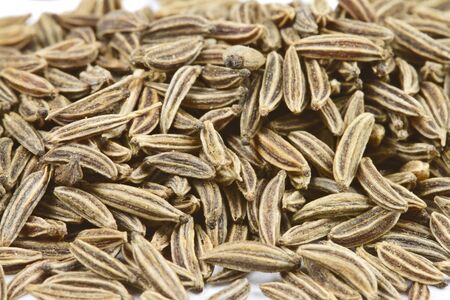 Close-up of cumin seeds on white background.の写真素材