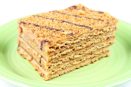 Traditional Armenian honey cake on green plate and white background.の写真素材