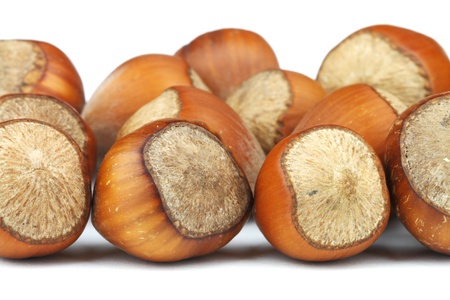 A handful of hazelnuts on a white background.の写真素材