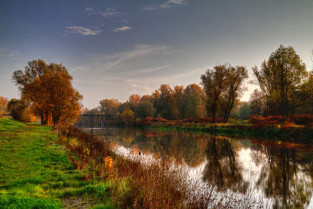 Nature in autumn color with river.の写真素材