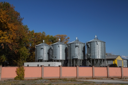 Four reservoirs for liquid chemicals with blue sky.のeditorial素材
