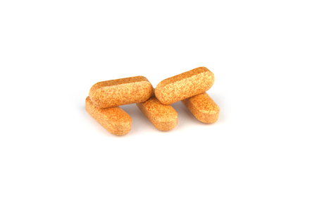 Vitamin C tablets on white background - extract from rose hips.の写真素材