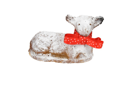 Easter lamb with red ribbon and powdered by sugar on white background.の写真素材