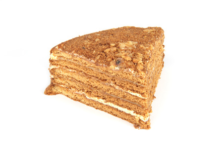 Piece of honey cake on white background.の写真素材