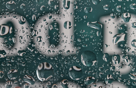Abstract background with water drops over letters.