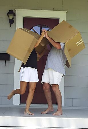 Young lovers fooling around and dancing on porch while moving in.の写真素材