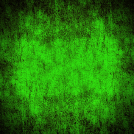 abstract green background or Christmas backdrop with bright center spotlight and black vignette borderの写真素材