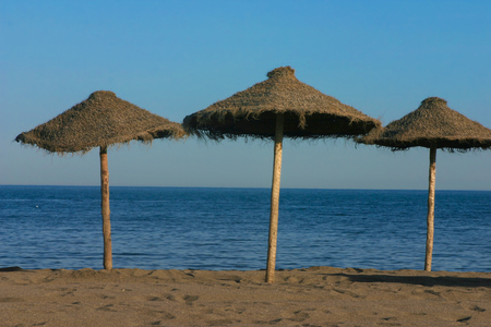 Straw umbrellas on a beautiful tropical beachの写真素材