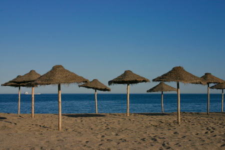 Straw umbrellas on a beautiful tropical beachの写真素材