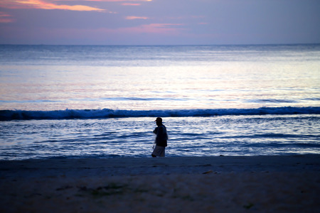 People stood watching the sea, Sunrise and happyの写真素材