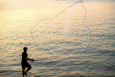 The fisherman cast a net the sea in the morning, at sunrise, Songkhla province, Thailand countryのeditorial素材