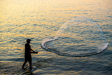The fisherman cast a net the sea in the morning, at sunrise, Songkhla province, Thailand countryのeditorial素材