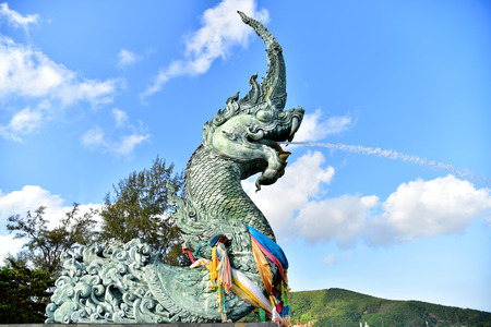 Naga sculptures spraying water A symbol of Songkhla Province, Thailand The floating Spraying water into the estuary lake is popular with tourists,Take pictures Songkhla Province,Thailand April 4, 2015のeditorial素材