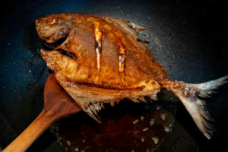 Crispy Fried Pomfret  in the frying pan,  Delicious and healthyの写真素材
