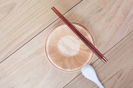 Empty bowl and chopsticks wooden on wood table backgroundの写真素材